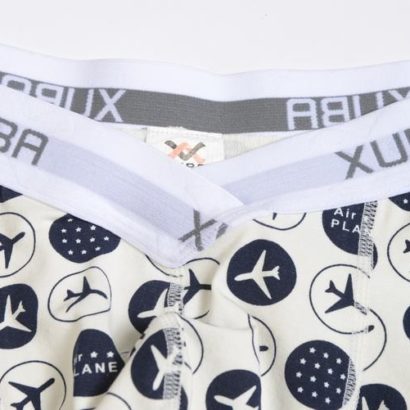 First Class white smoke cotton boxer decorated with planes and stars and contains a grey belt