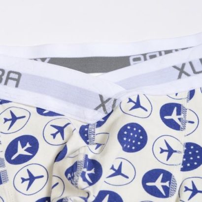 First Class white cotton boxer decorated with blue planes and stars and contains a grey belt