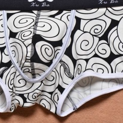 First class black cotton boxer decorated with beige circles and contains black belt