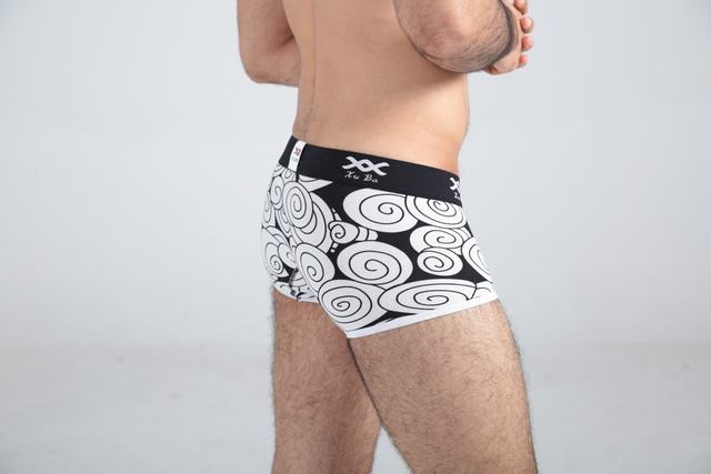 First class black cotton boxer decorated with beige circles and contains black belt