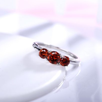 Luxurious silver 925 ring inlaid with three red zircon bezel and side white special crystals