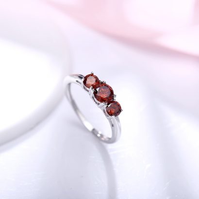 Luxurious silver 925 ring inlaid with three red zircon bezel and side white special crystals