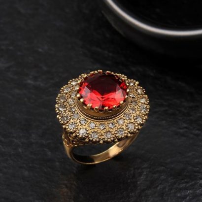 Copper ring three times of gold plating with a classical design and inlaid with red zircon