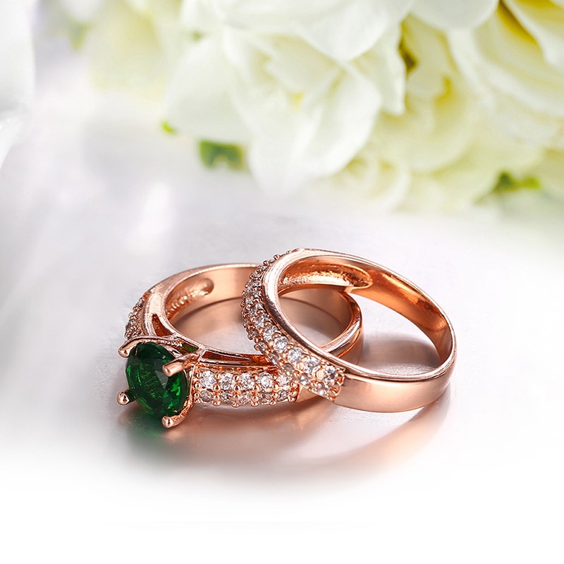 Copper twins ring inlaid with white crystals and a green olive special zircon