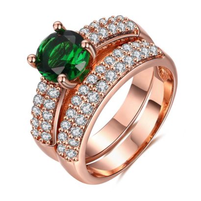 Copper twins ring inlaid with white crystals and a green olive special zircon