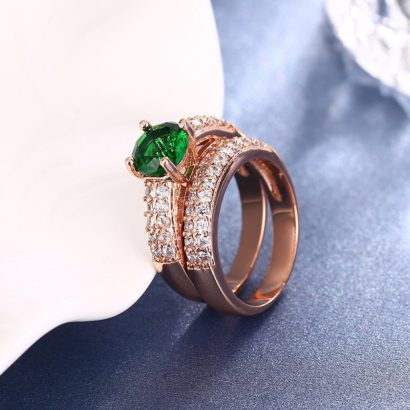 Copper twins ring inlaid with white crystals and a green olive special zircon