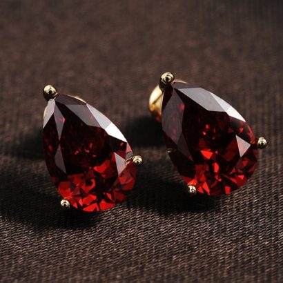 A unique simple earring design three times gold plated and inlaid with swiss red zircon