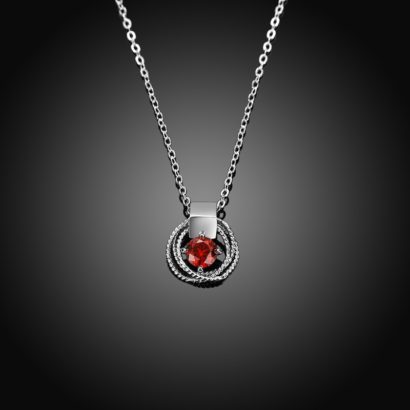 Braid necklace plated with platinum and has a red zircon in the middle