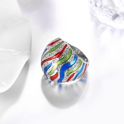 A unique ring plated with platinum and inlaid with diamond crystals and decorated by colored oil drip