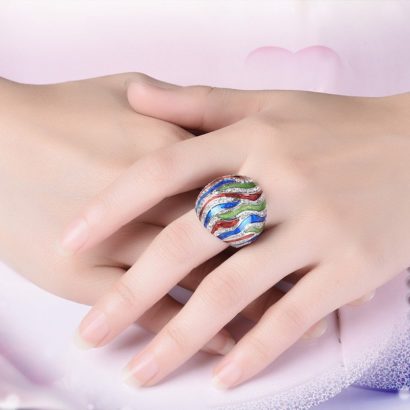 A unique ring plated with platinum and inlaid with diamond crystals and decorated by colored oil drip