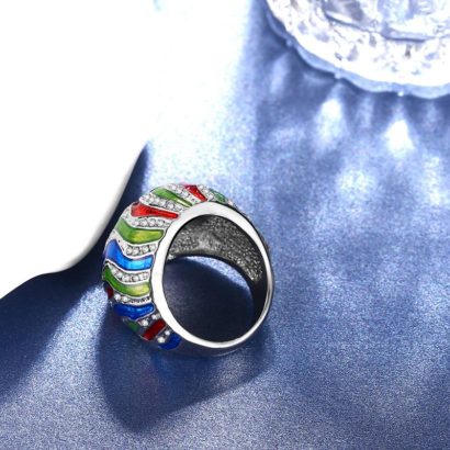 A unique ring plated with platinum and inlaid with diamond crystals and decorated by colored oil drip