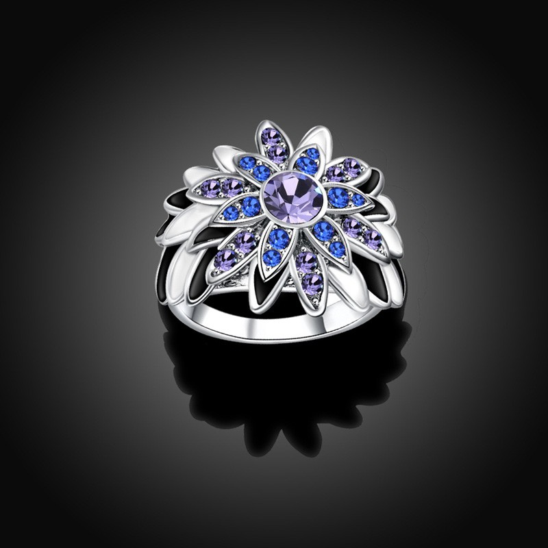 Water drop is a unique ring plated with platinum and inlaid withblue and violet diamond crystals and decorated by black oil drip