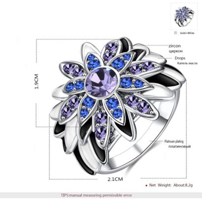 Water drop is a unique ring plated with platinum and inlaid withblue and violet diamond crystals and decorated by black oil drip