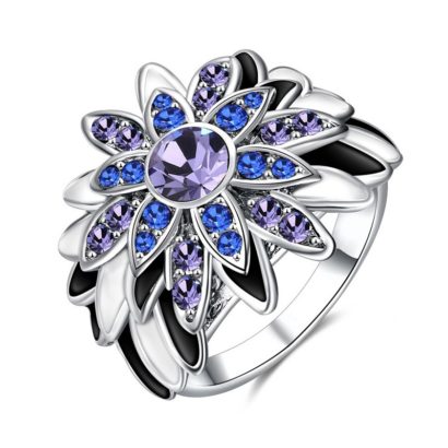 Water drop is a unique ring plated with platinum and inlaid withblue and violet diamond crystals and decorated by black oil drip