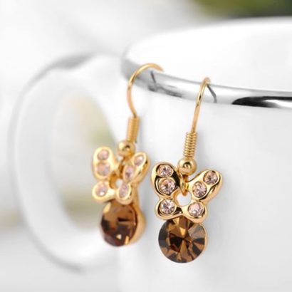 The butterfly earring is three times gold plated inlaid with genuine austrian white crystals and a champagne zircon