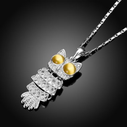 The owl necklace plated with platinum and the eyes are inlaid with brown opals.