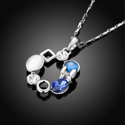 A unique design of combined ornaments plated with platinum, inlaid with white opal, blue glass stone and a crystal diamond