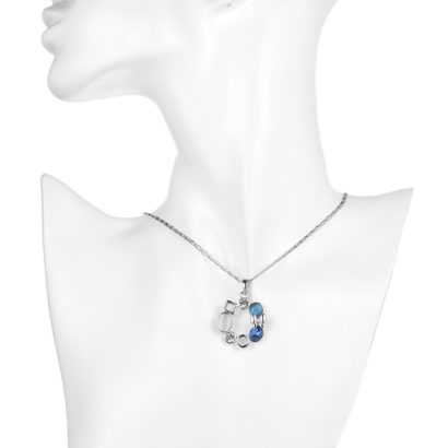 A unique design of combined ornaments plated with platinum, inlaid with white opal, blue glass stone and a crystal diamond