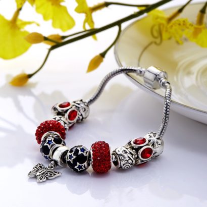 Silver bangle inlaid with special ornaments and red crystal diamonds and a unique design of butterfly