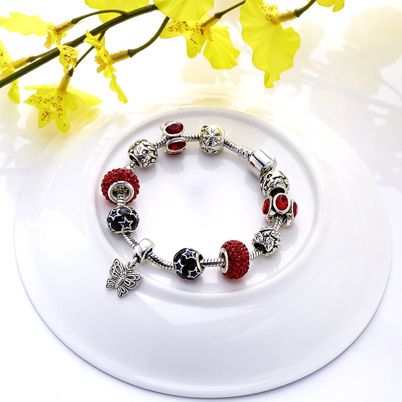 Silver bangle inlaid with special ornaments and red crystal diamonds and a unique design of butterfly