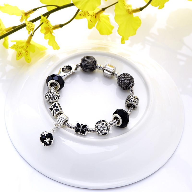 Silver bangle inlaid with special ornaments and a black crystal diamond