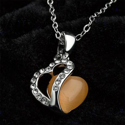 Heart necklace, plated with gold and inlaid with white crystals and an orange opal