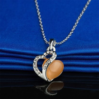 Heart necklace, plated with gold and inlaid with white crystals and an orange opal