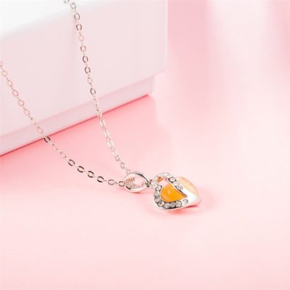 Heart necklace, plated with gold and inlaid with white crystals and an orange opal