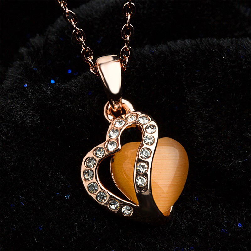 Heart necklace, plated with gold and inlaid with white crystals and an orange opal