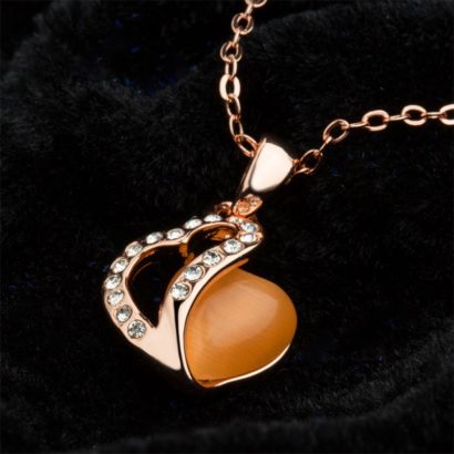 Heart necklace, plated with gold and inlaid with white crystals and an orange opal