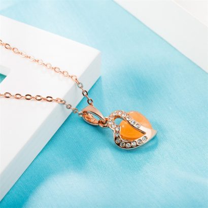 Heart necklace, plated with gold and inlaid with white crystals and an orange opal