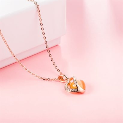 Heart necklace, plated with gold and inlaid with white crystals and an orange opal
