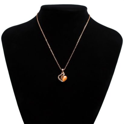 Heart necklace, plated with gold and inlaid with white crystals and an orange opal