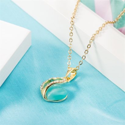 Heart necklace, plated with gold and inlaid with white crystals and a sky blue opal