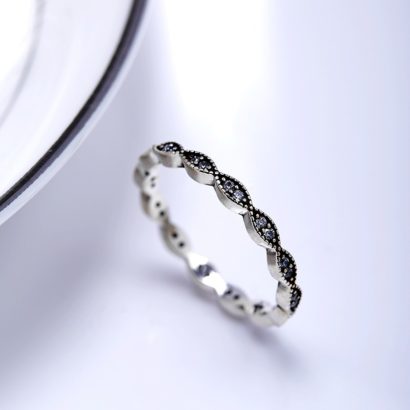 Silver ring with a simple old fashion design inlaid with zircon crystals